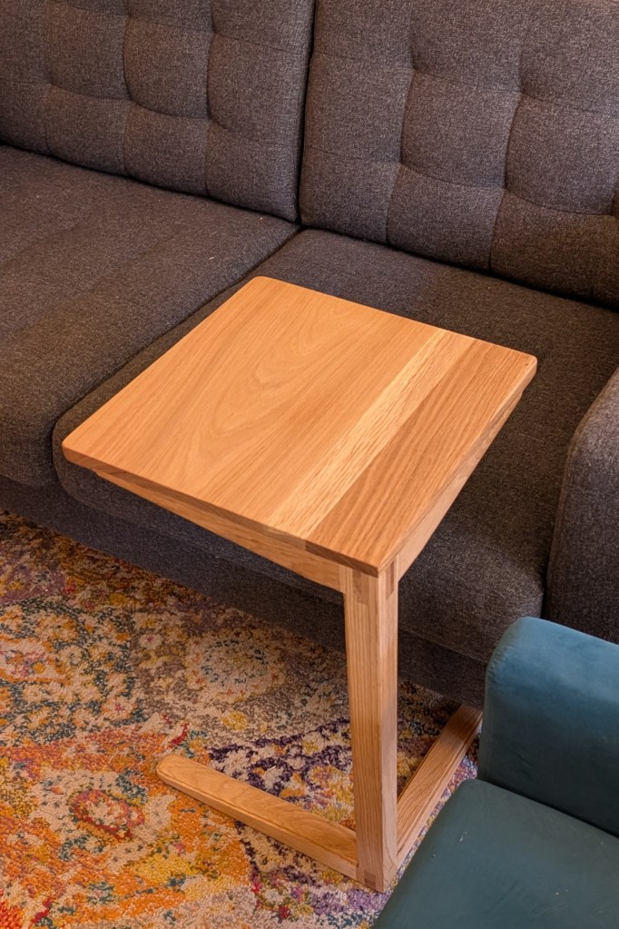 Cantilevered side table by sofa and chair