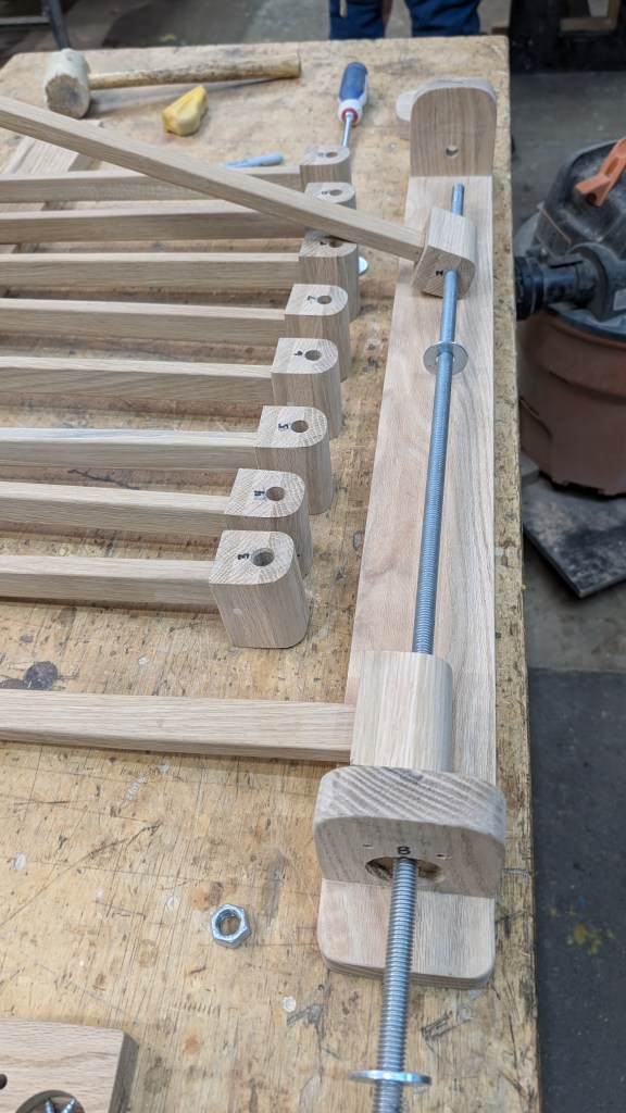 Insert threaded rod through each arm